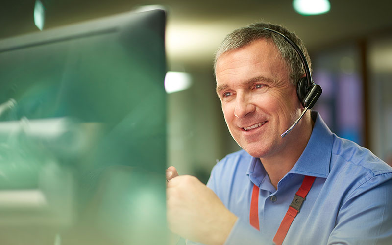 Man with headset on computer